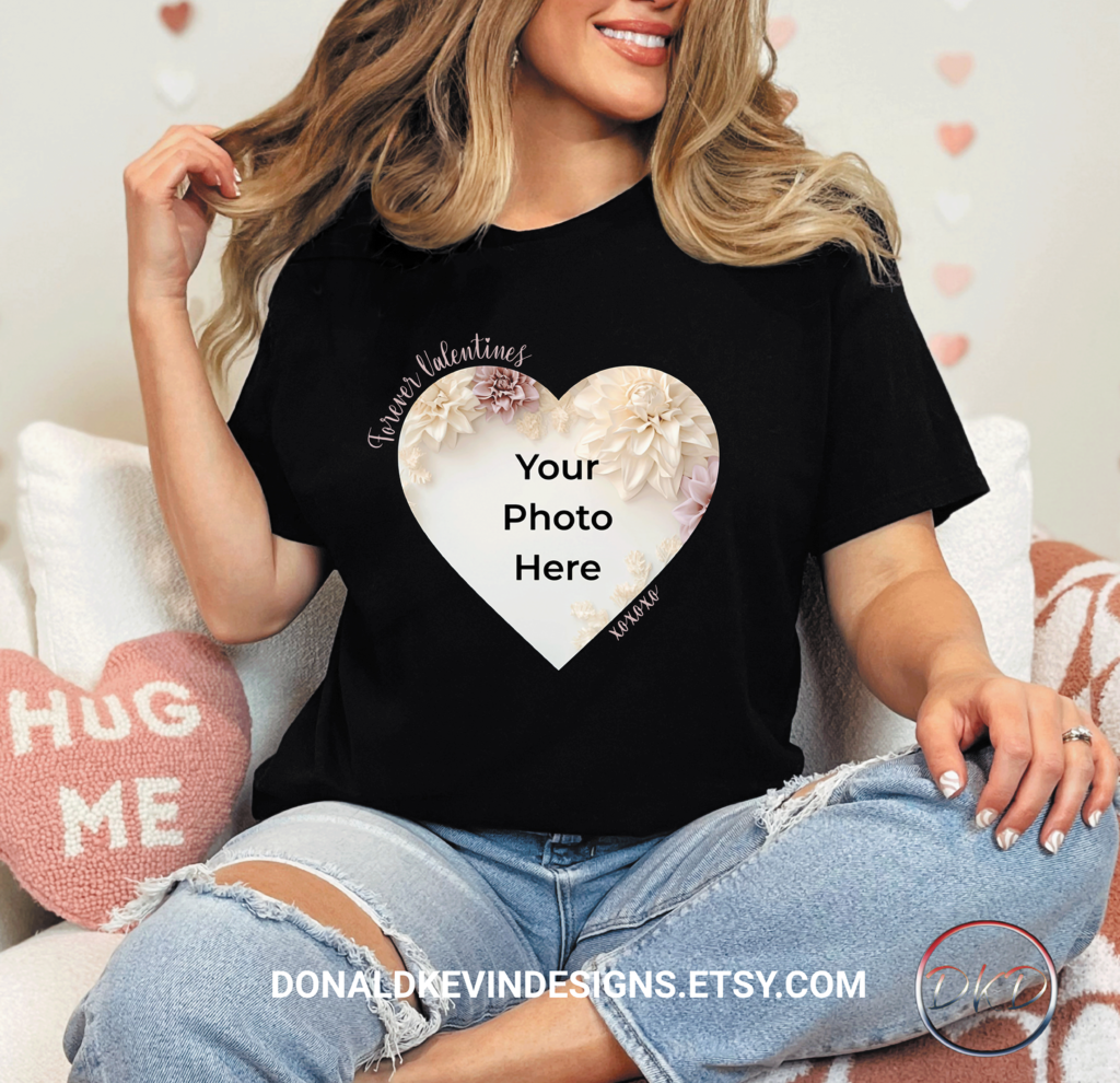 Girl sitting wearing a black tshirt with a heart shape. Inside the heart is a floral background with text that reads your photo here.